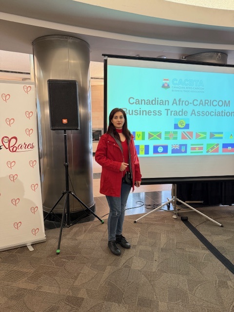 A Digibot team member in front of the Canadian Afro-CARICOM Business Trade Association presentation screen, December 2024
