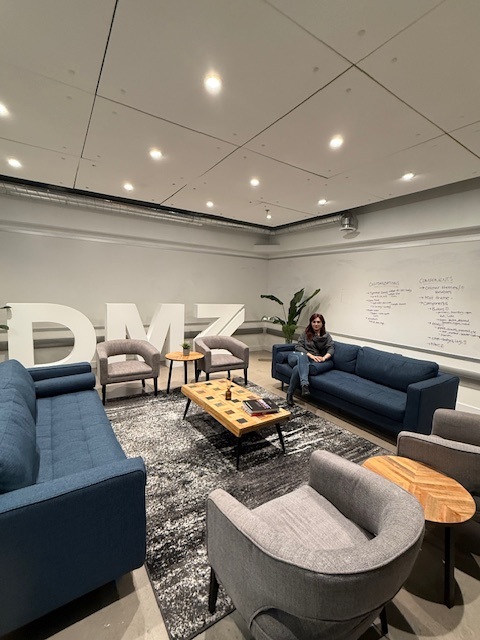 The DMZ lounge in Toronto with Elham Mozaffari seated on a sofa, November 2024